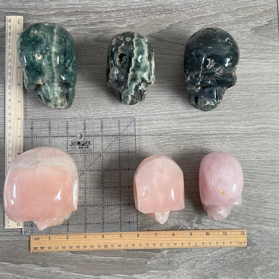 Wholesale Lot of 6 crystal skulls; three rose quartz and three Kabamba jasper. 