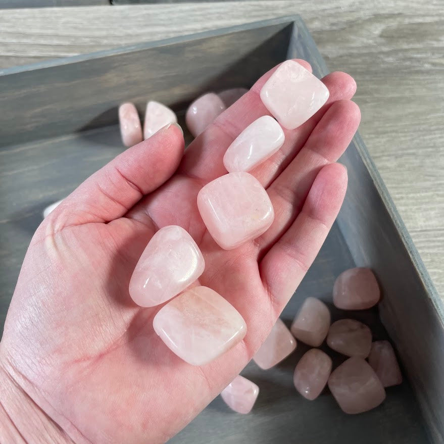 Polished rose quartz stones in soft pink tones sold by the pound