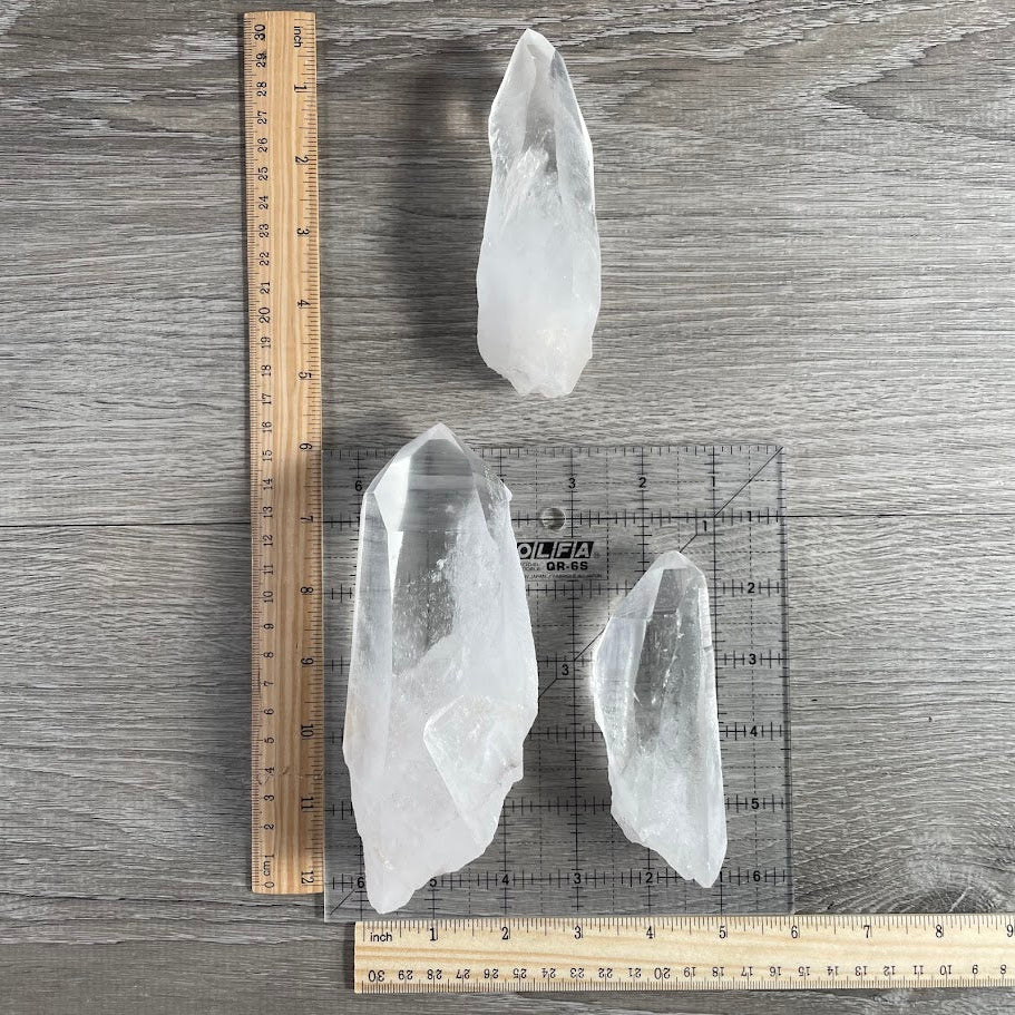 Lot of three lemurian points with grid and rulers for size reference.