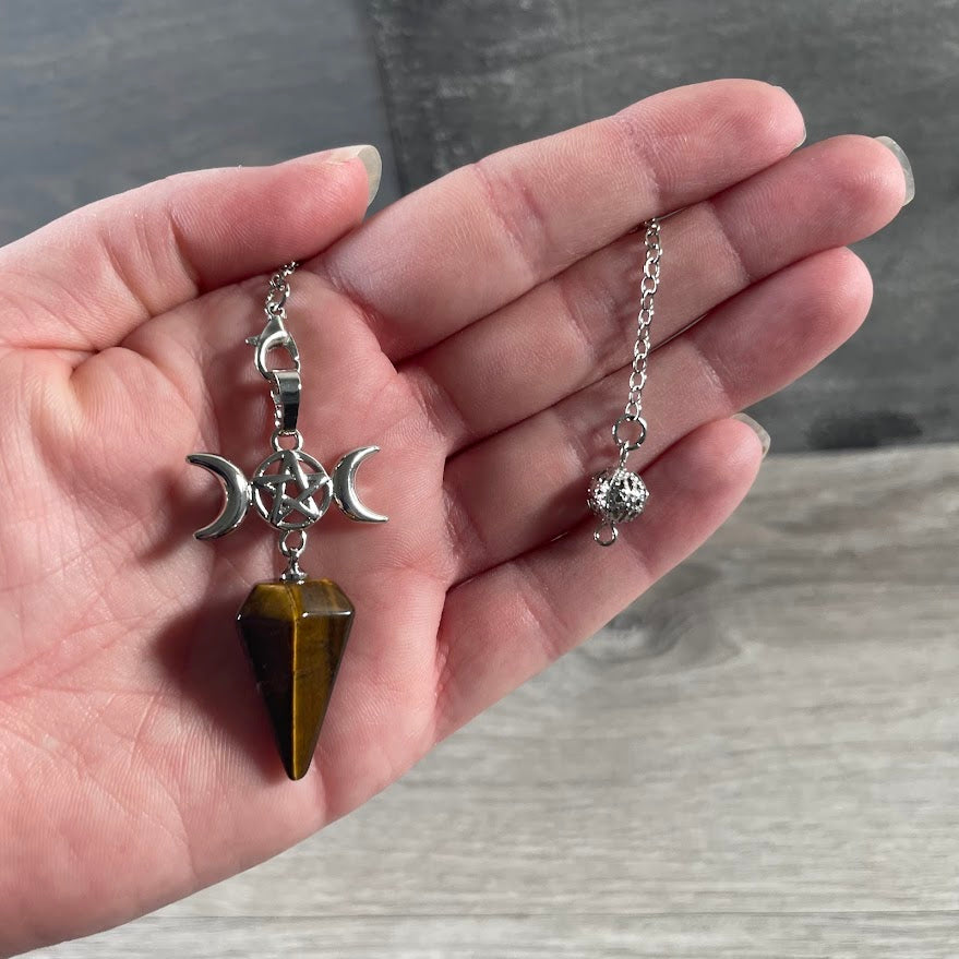 Tiger Eye Moon phase pendulum with polished gemstone for spiritual practice