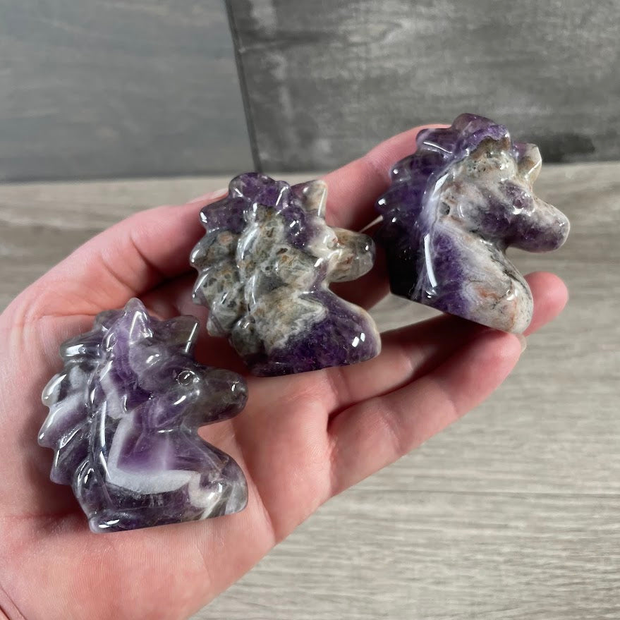 Amethyst crystal unicorn figurine carved from gemstone for spiritual décor