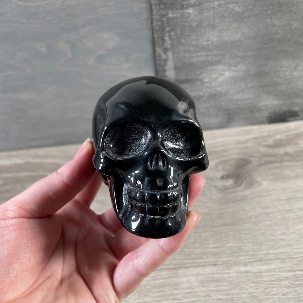 Polished black crystal skull carved from natural obsidian