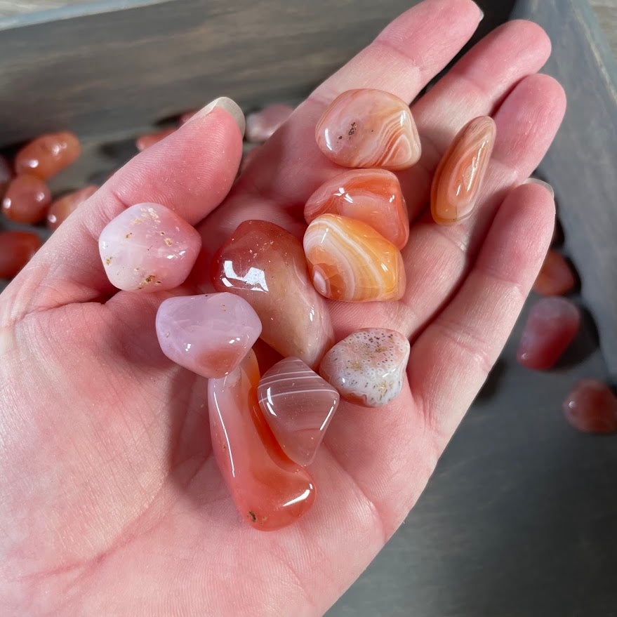 Orange carnelian tumbled stones for crystal retail displays