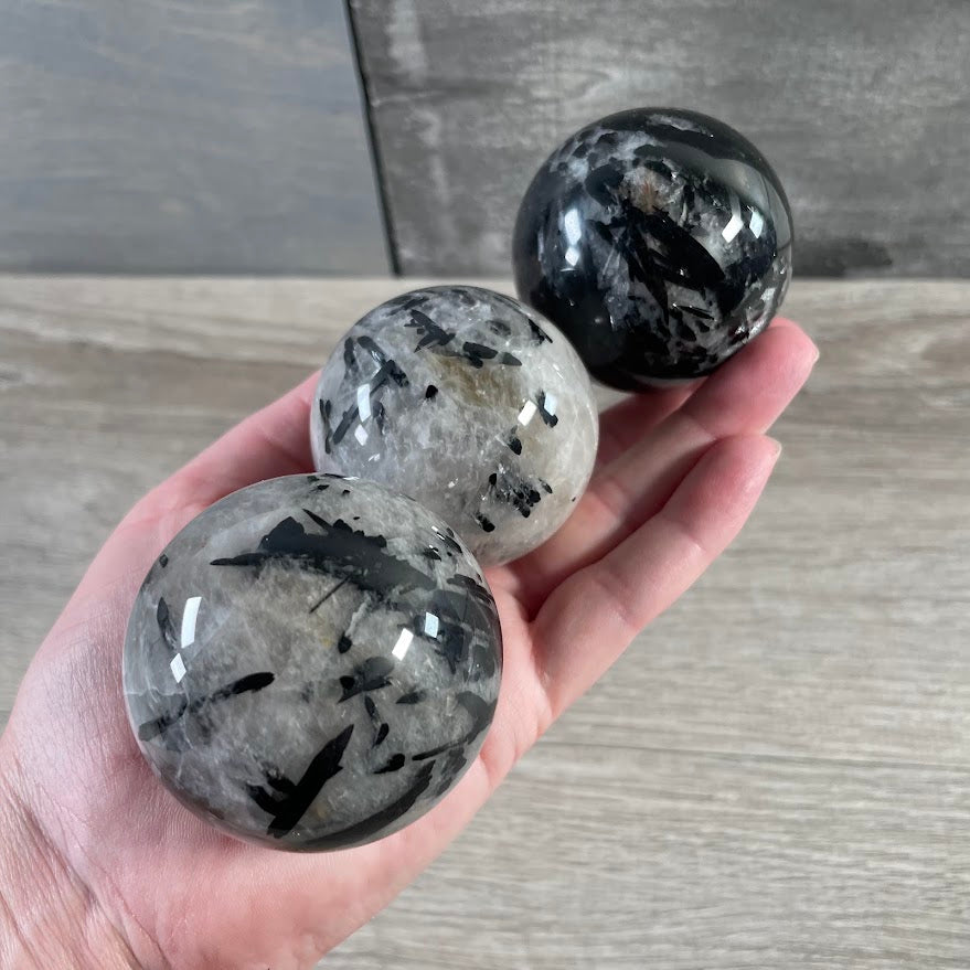 Tourmalinated quartz gemstone sphere for Reiki, meditation, and metaphysical retail