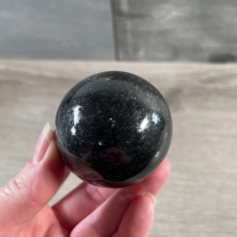 Nuummite crystal sphere for meditation, energy work, and decor