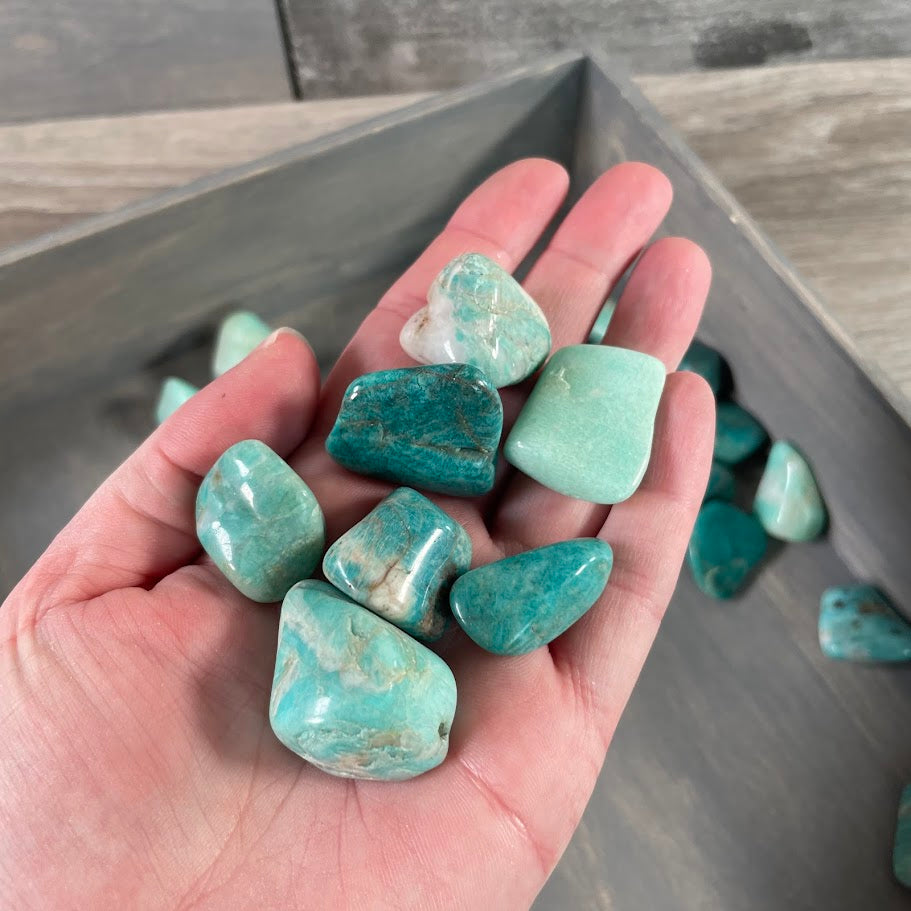 Natural amazonite tumbled stones showing smooth polished surfaces and unique blue-green mineral patterns