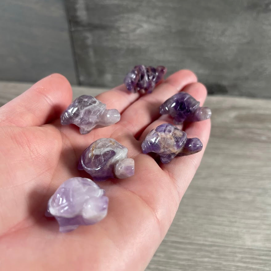 Amethyst gemstone animal figurines featuring carved turtle designs for retail displays