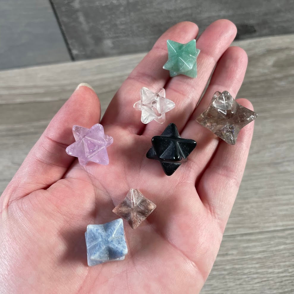 Assorted Brazilian Merkaba crystals carved from polished natural gemstones in sacred geometry star shapes