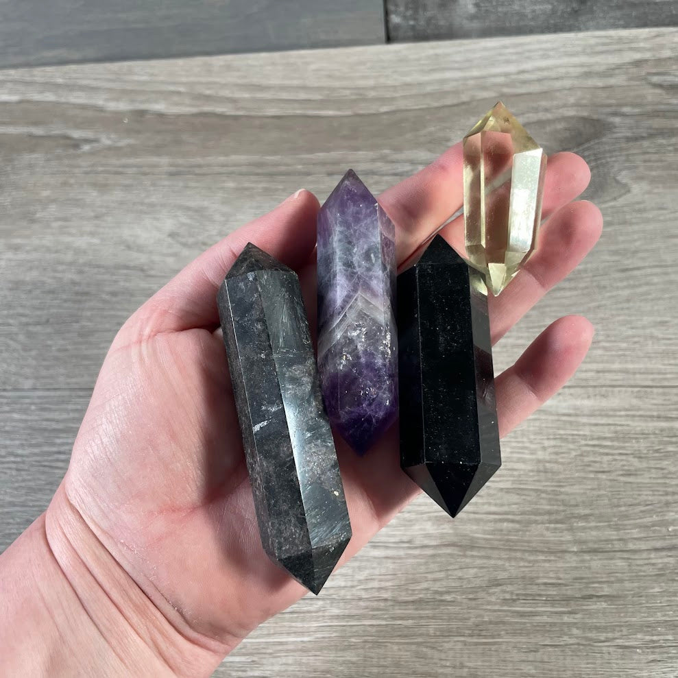 assorted double terminated gemstone wands with points at both ends, sold by the ounce.
