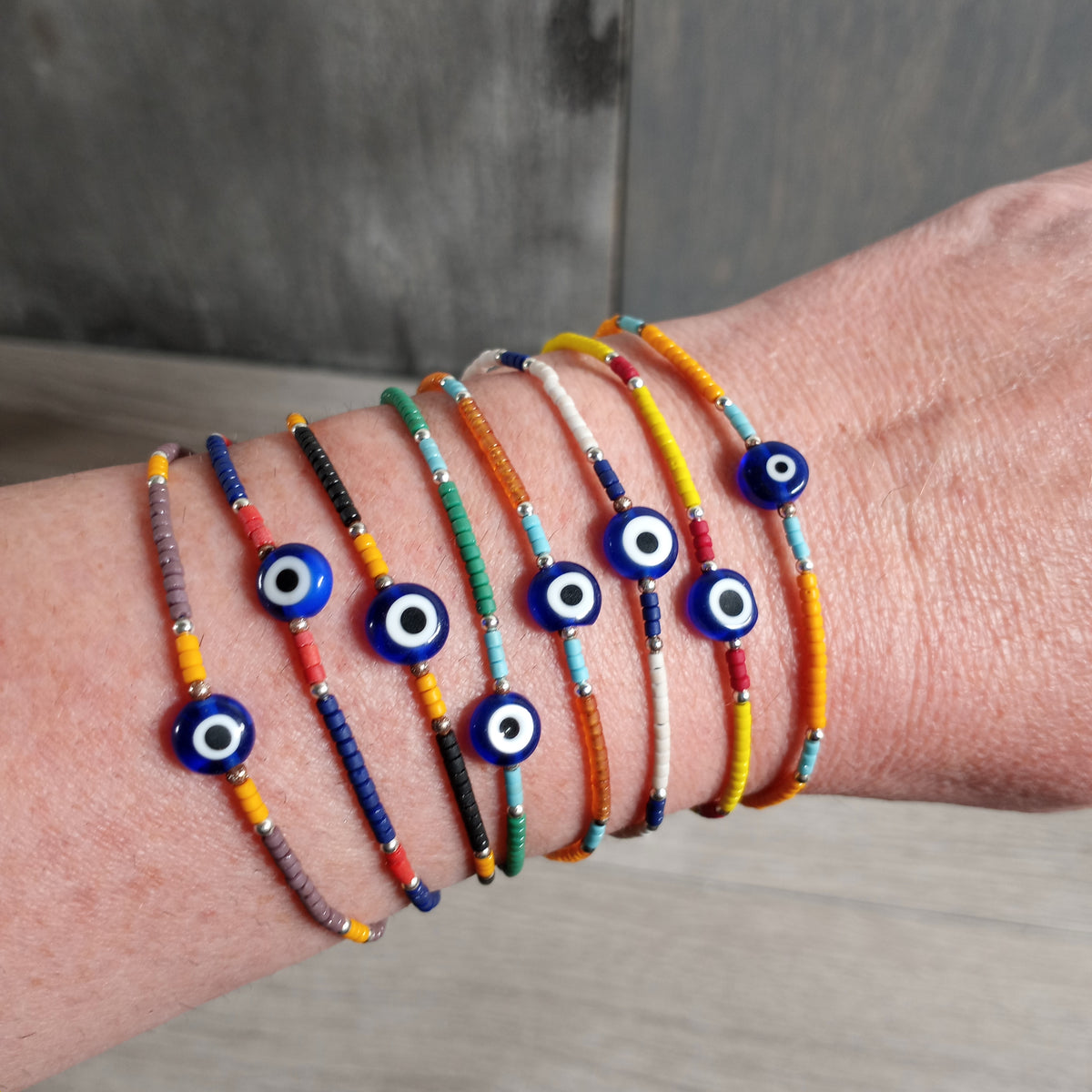 Wooden beaded bracelet with evil eye charm and lobster claw clasp
