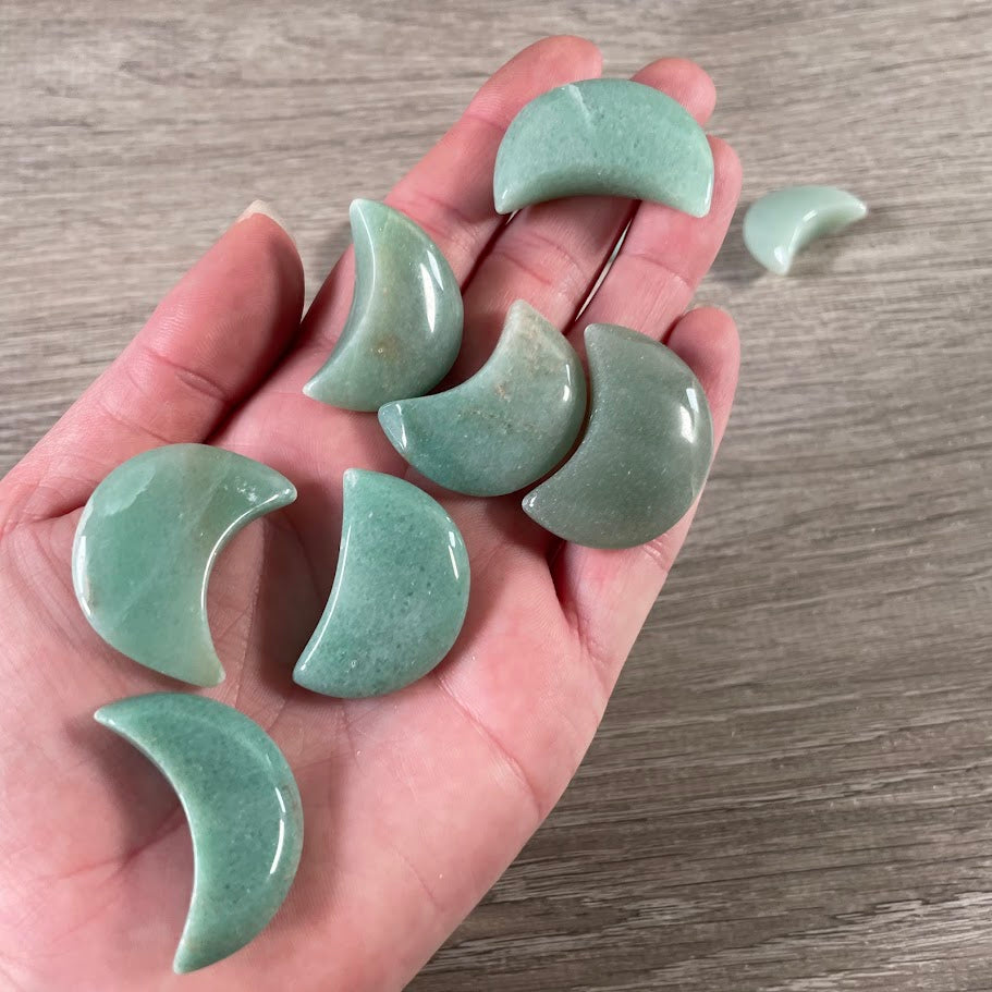Brazilian aventurine gemstone crescent moon carving showing natural stone colors and markings.
