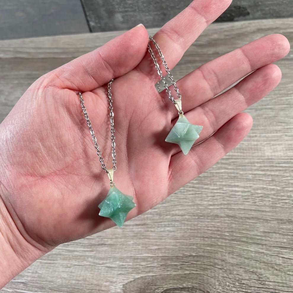 Green aventurine crystal pendant necklace displayed with stainless steel chain