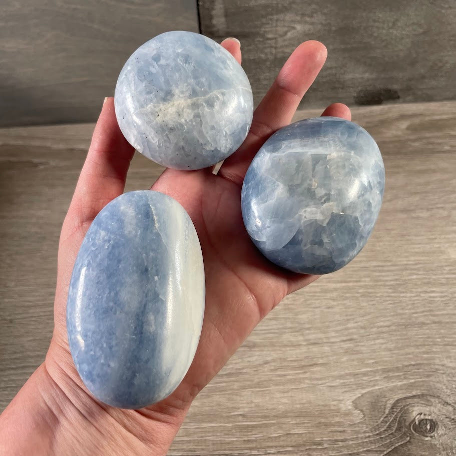 Bulk natural crystal palm stone blue calcite sold by weight for retail gemstone businesses