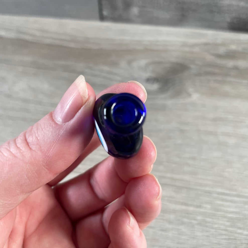 Decorative evil eye perfume bottle in blue glass.
