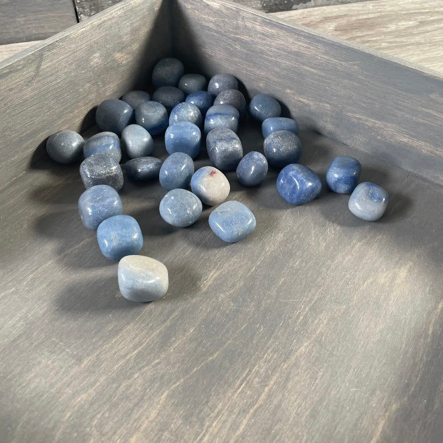 Blue quartz polished gemstones in a one pound lot with assorted natural shapes and blue color variations