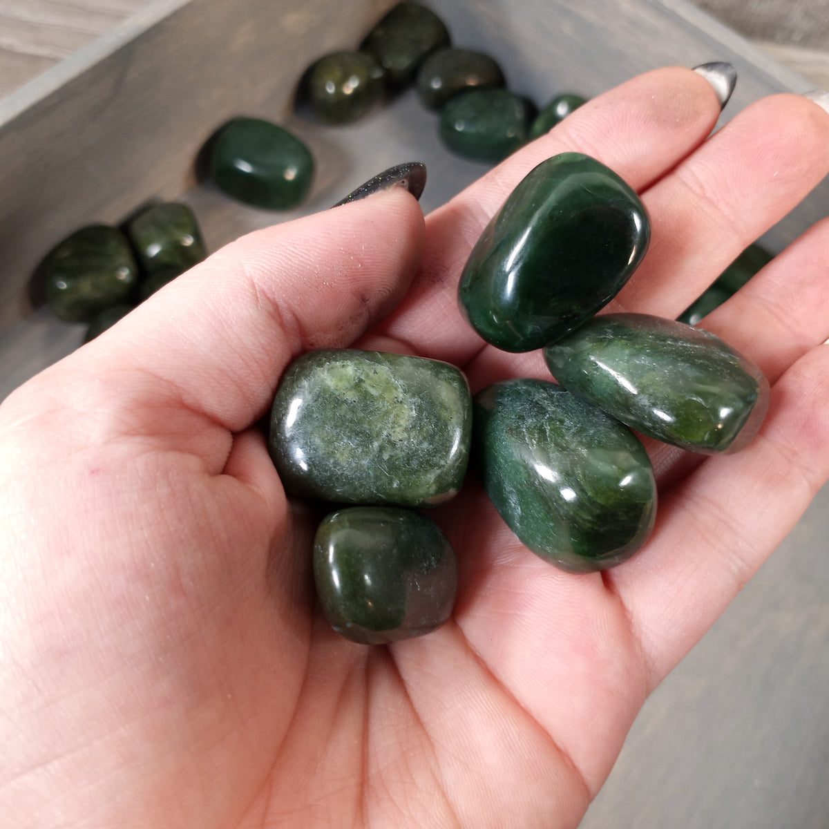 Bulk BC Jade stones, polished and smooth for decorative displays or resale.