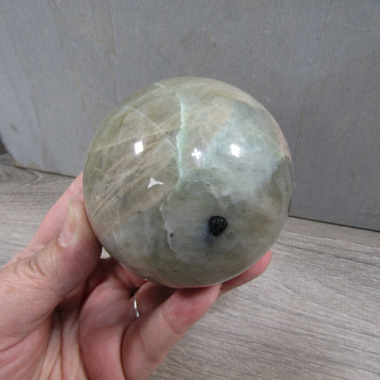 Large moonstone garnierite sphere used as a centerpiece for meditation and tranquility