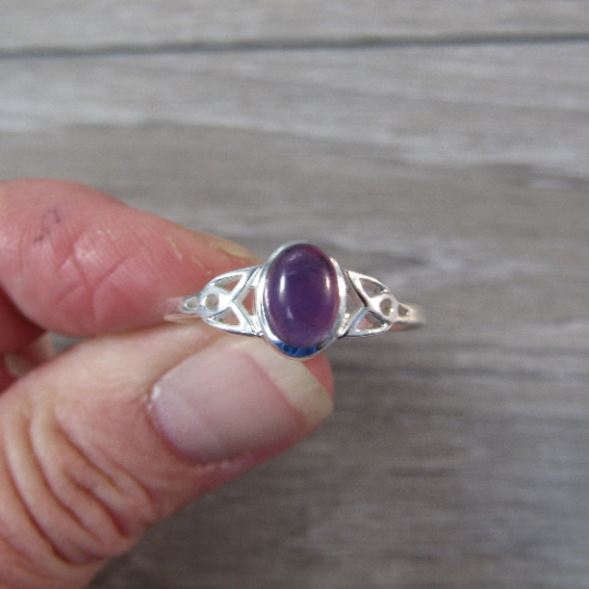 Sterling silver ring with celtic trinity knot band and amethyst center stone