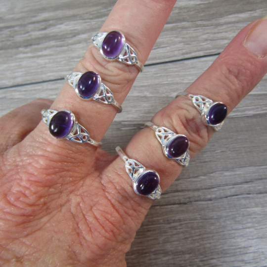 Sterling silver ring with celtic trinity knot band and amethyst center stone