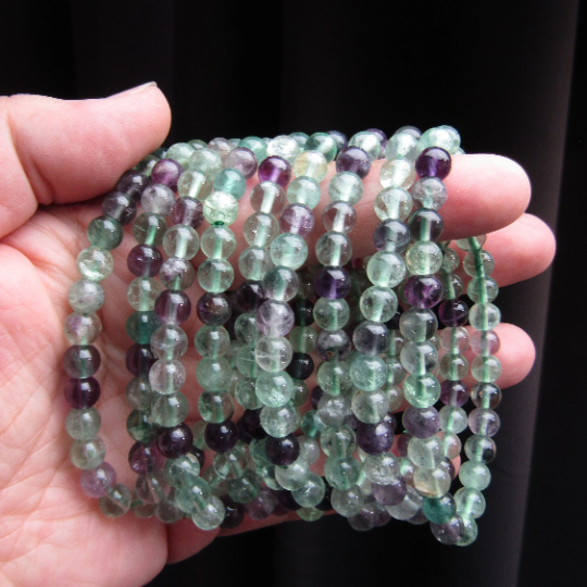 Stretchy bracelet made from 6mm round green and purple fluorite beads