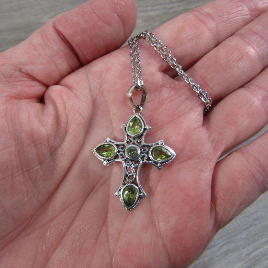 Peridot cross pendant on a chain