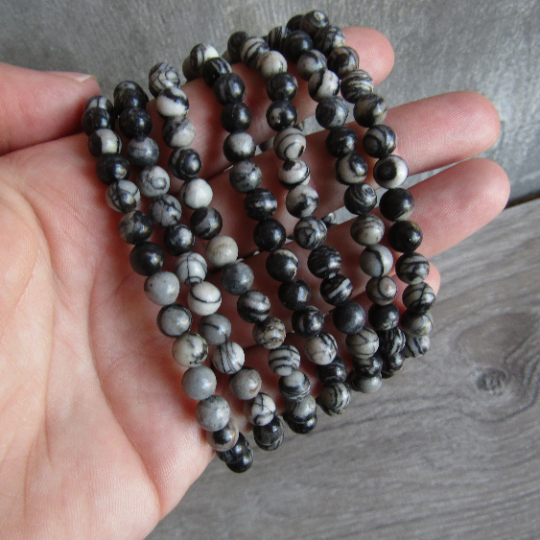 Stretchy bracelet made from 6mm round spiderweb jasper beads