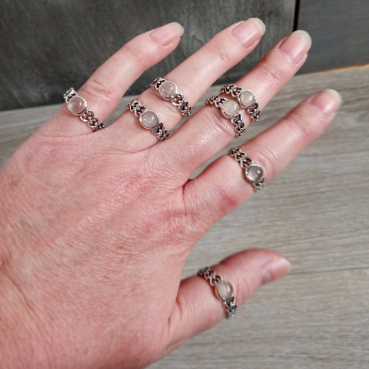 Sterling Silver ring with the band made connected hearts with a round rose quartz center stone