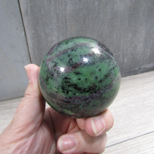 High-quality large ruby in zoisite display sphere with polished finish