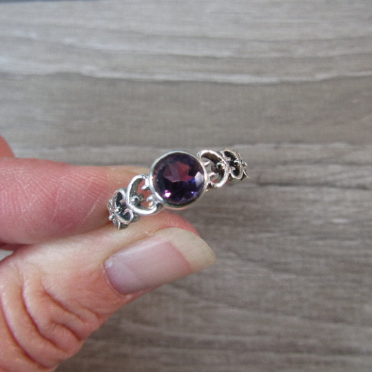 Sterling Silver ring with the band made connected hearts with a round amethyst center stone