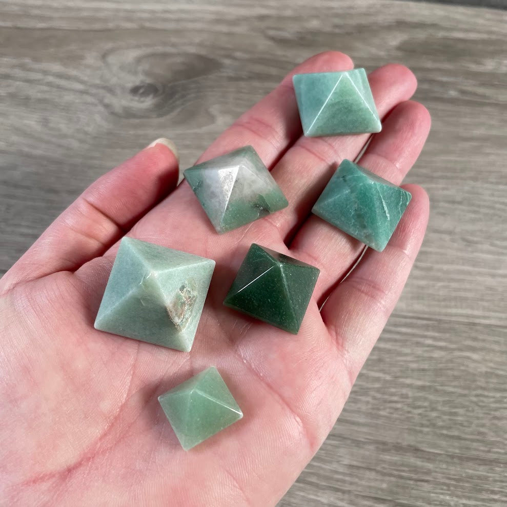 Small handmade green aventurine gemstone pyramids from Brazil displayed together