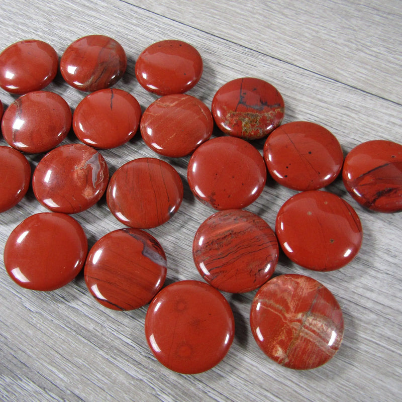 Round red jasper flat gemstone disk for base chakra alignment