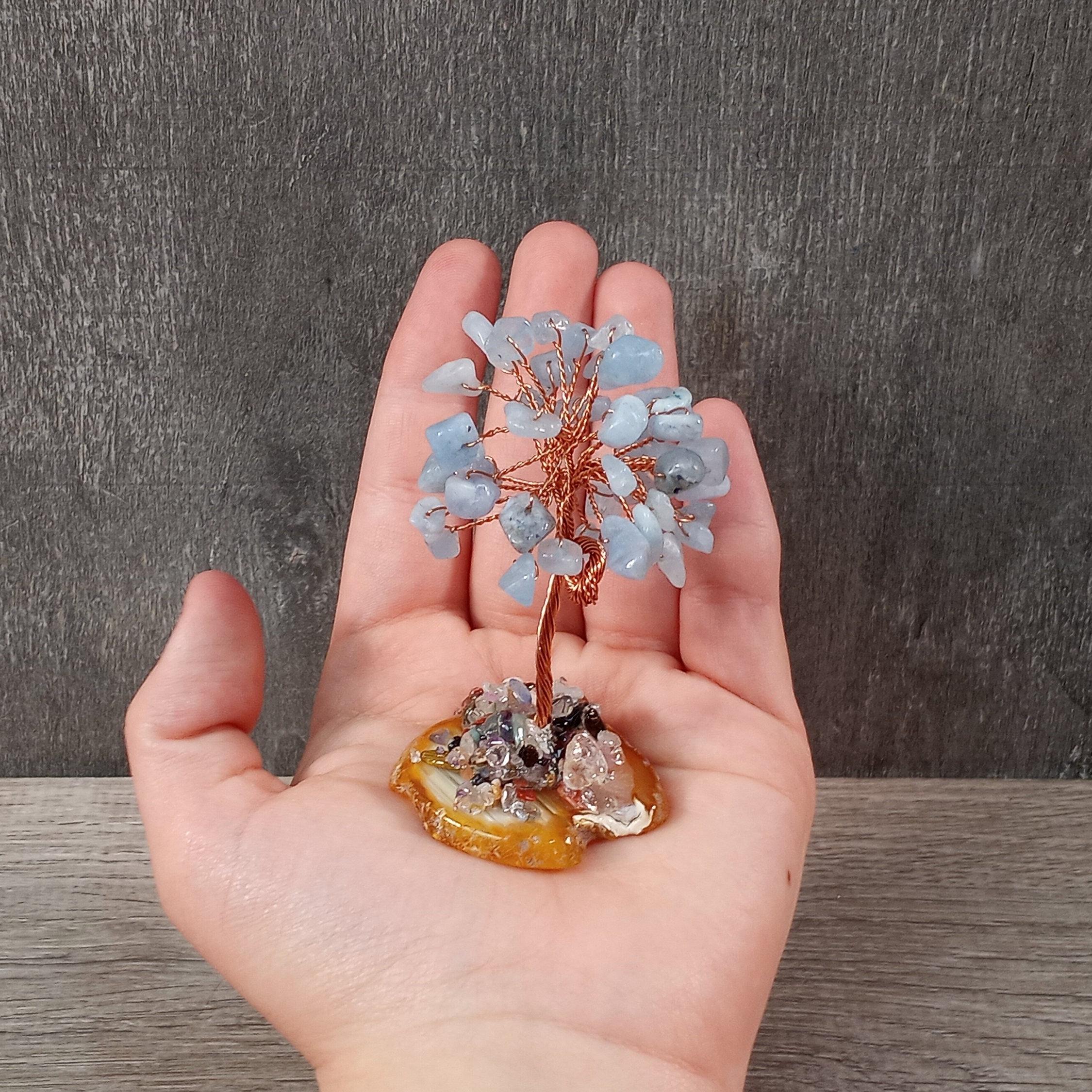 Decorative aquamarine and copper tree with grounding agate base