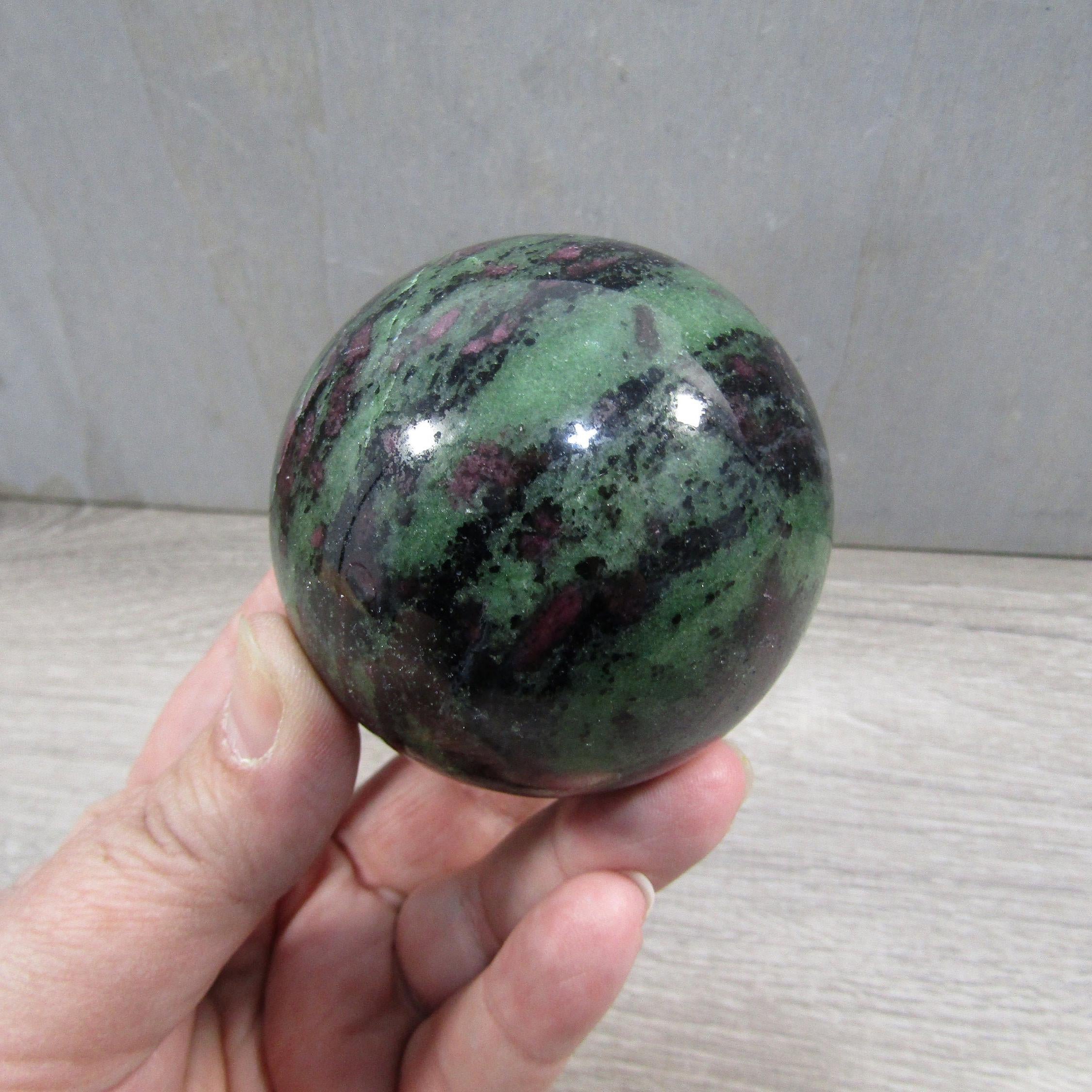 Unique ruby in zoisite sphere showing intricate green and black patterns