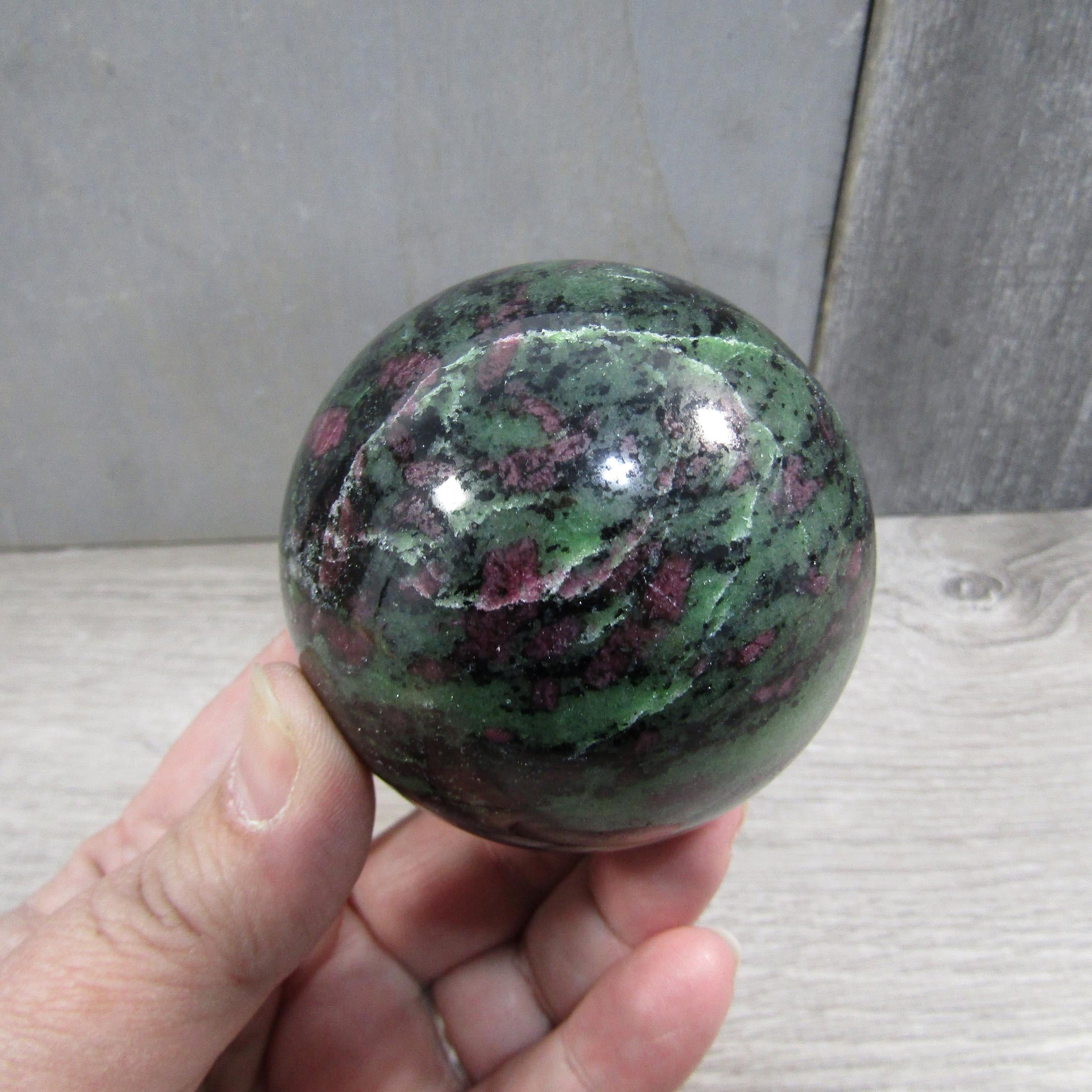 Close-up of ruby in zoisite display sphere with natural patterns