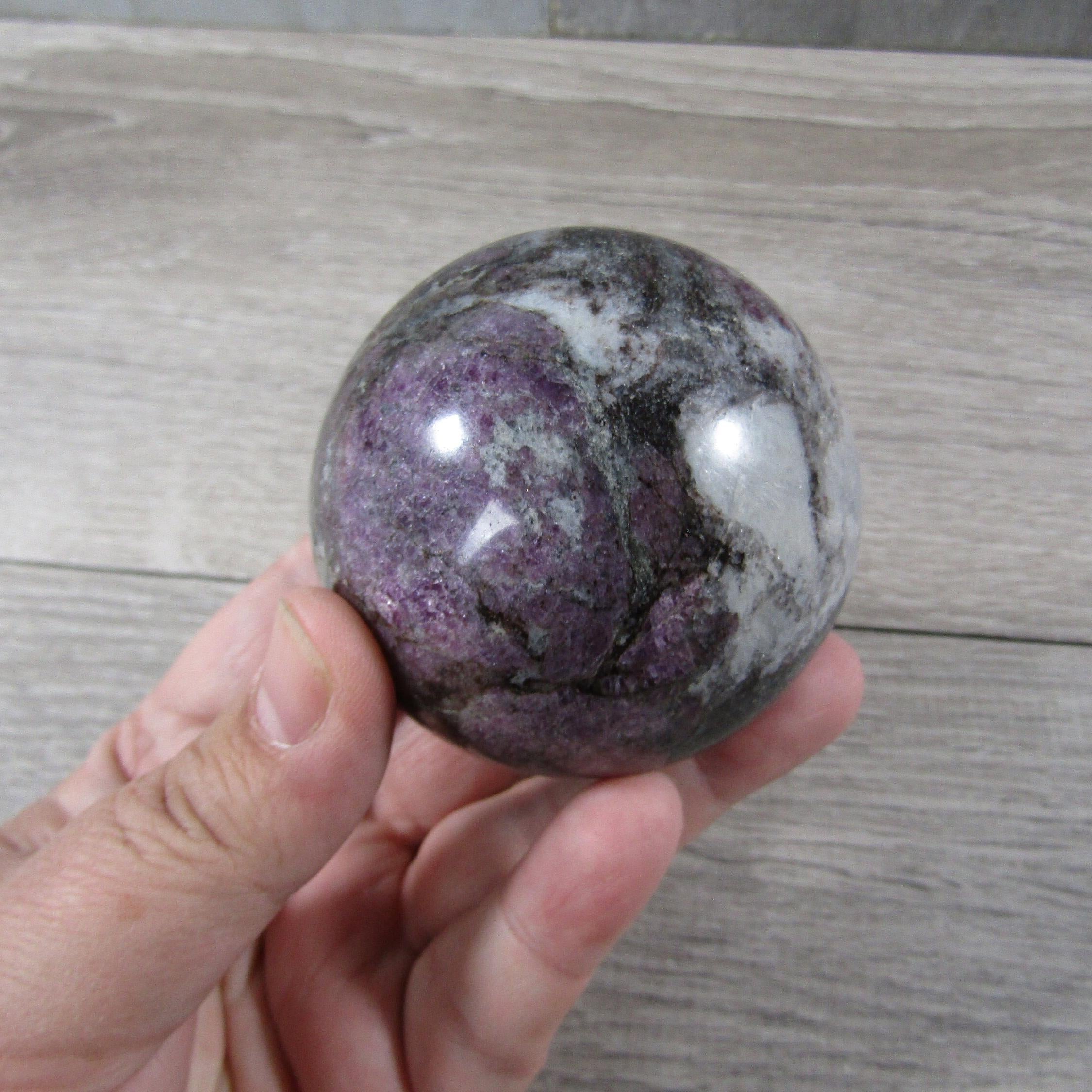 Close-up of polished large spinel sphere showing intricate patterns