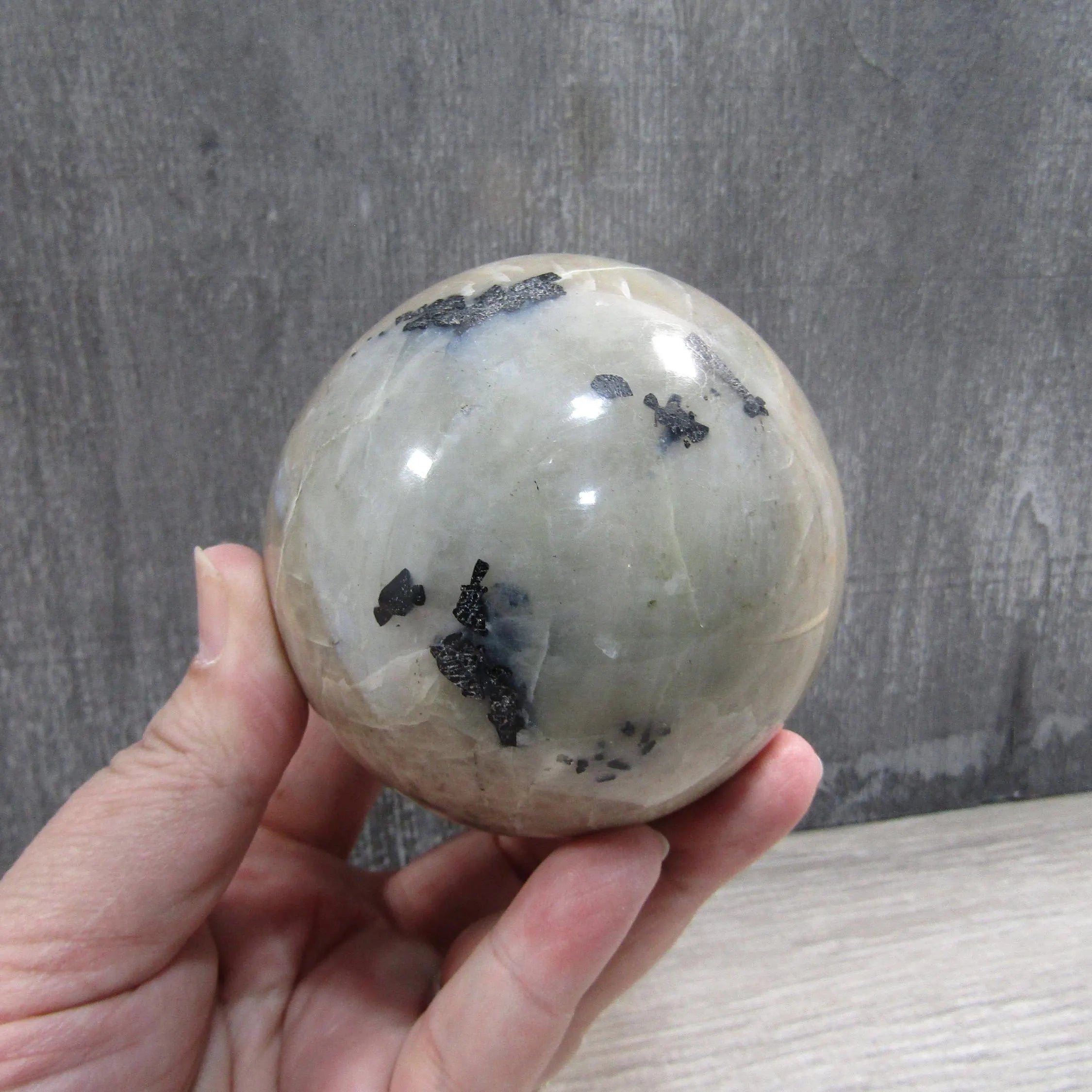 Polished surface of large moonstone garnierite sphere 