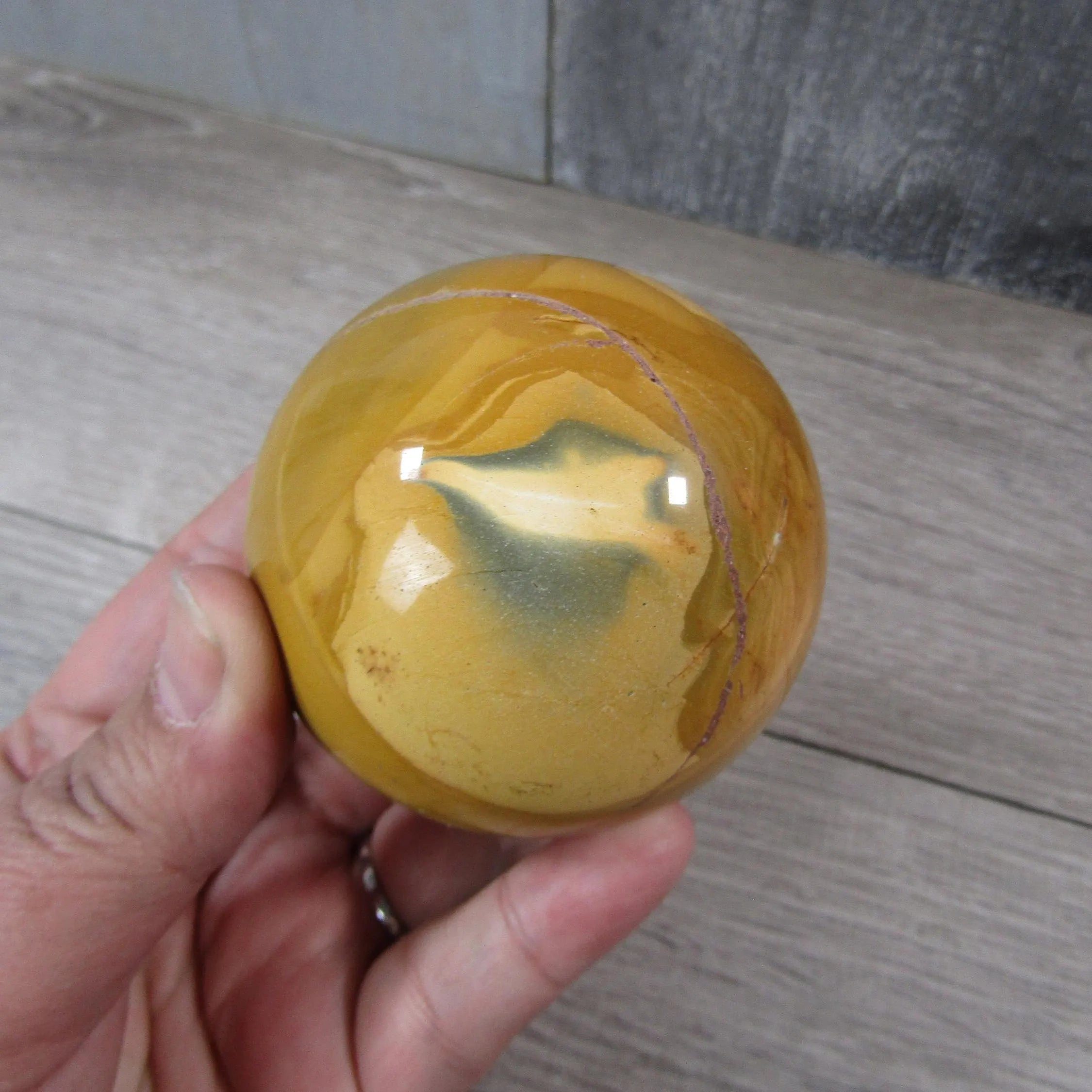 Close-up of Large Mookaite Jasper Sphere highlighting its smooth, polished surface.