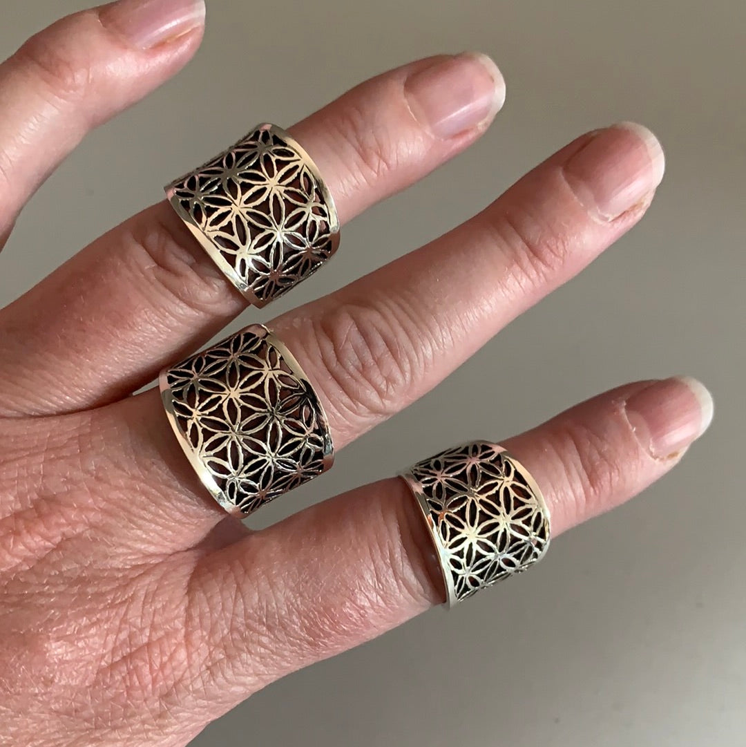 Flower of Life rings with a wide band for resale.