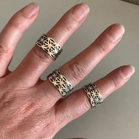 Close-up view of a sterling silver ring featuring the Flower of Life symbol.