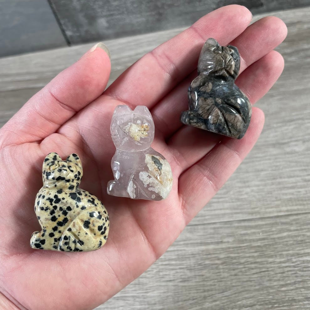 Assorted crystal animal figurines shaped like cats for boutique and gift shop displays.