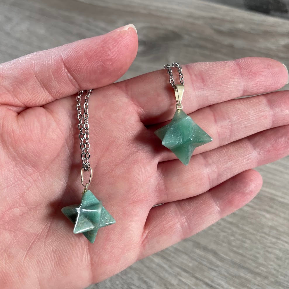 Green aventurine crystal pendant necklace displayed with stainless steel chain