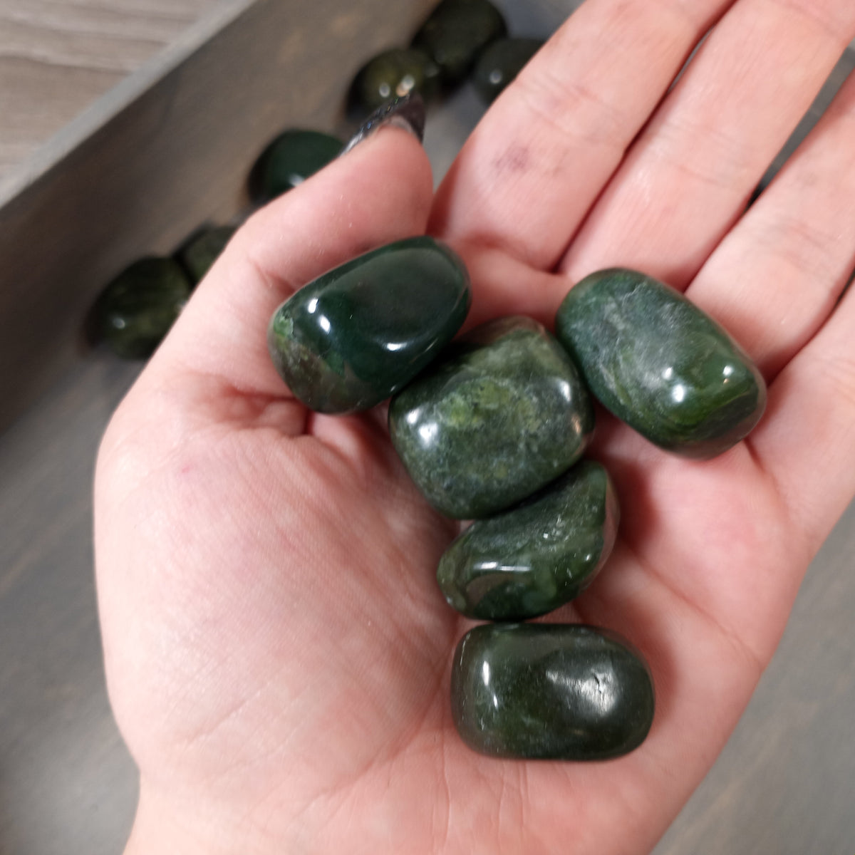 Green jade tumbled stones from British Columbia sold by the pound for gemstone displays and collections