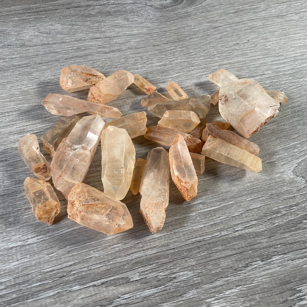 Raw Tangerine Quartz crystal points with natural golden orange mineral staining