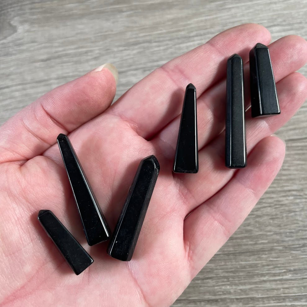 Small obsidian natural gemstone obelisk from Brazil for crystal shops and collectors.