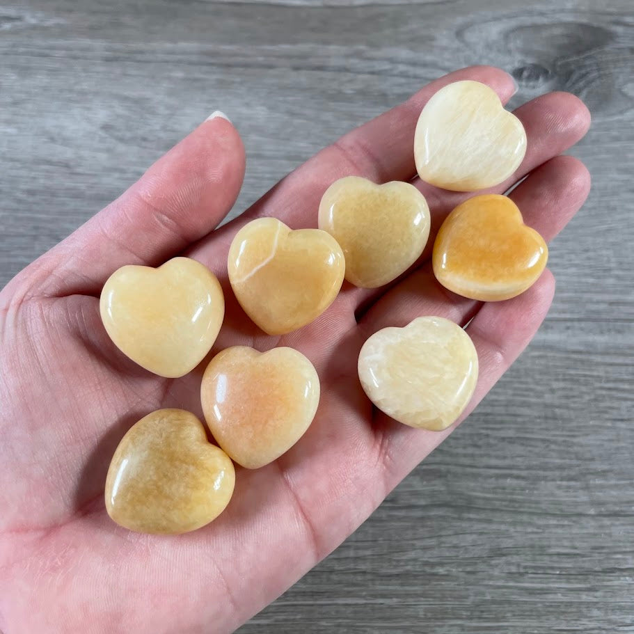 Polished orange calcite heart-shaped pocket stone 1-inch wholesale gemstone crystal