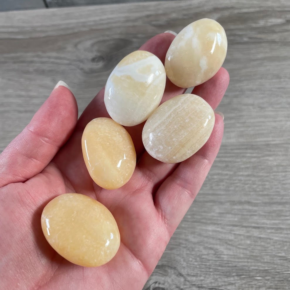 Orange calcite natural gemstone pocket and palm stones from Afghanistan