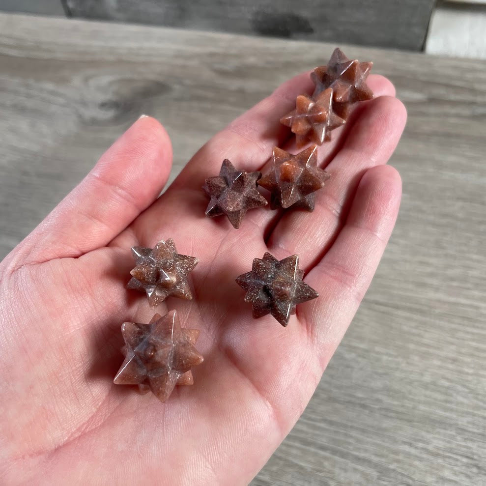 Wholesale red aventurine geometric crystal star showing detailed pointed carving