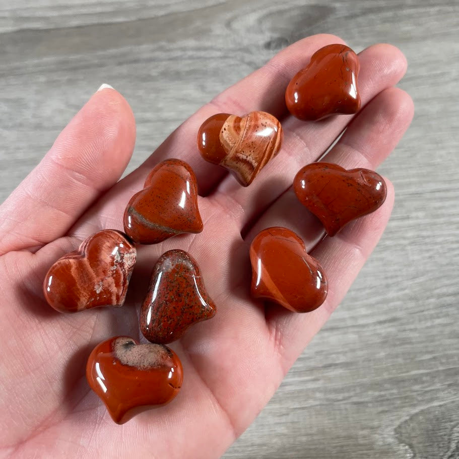 Heart-shaped red jasper crystal pocket stones measuring approximately 25mm