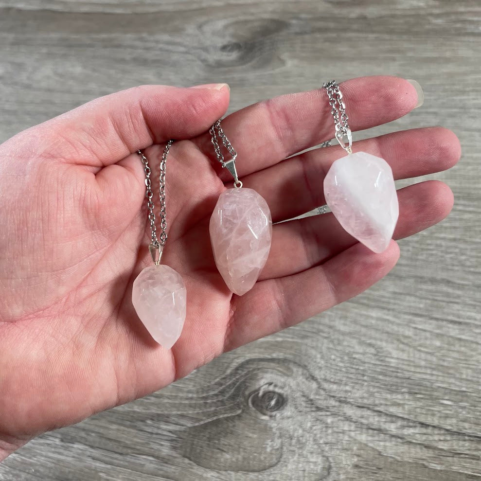 Flame-shaped rose quartz crystal pendant necklace with stainless steel chain detail