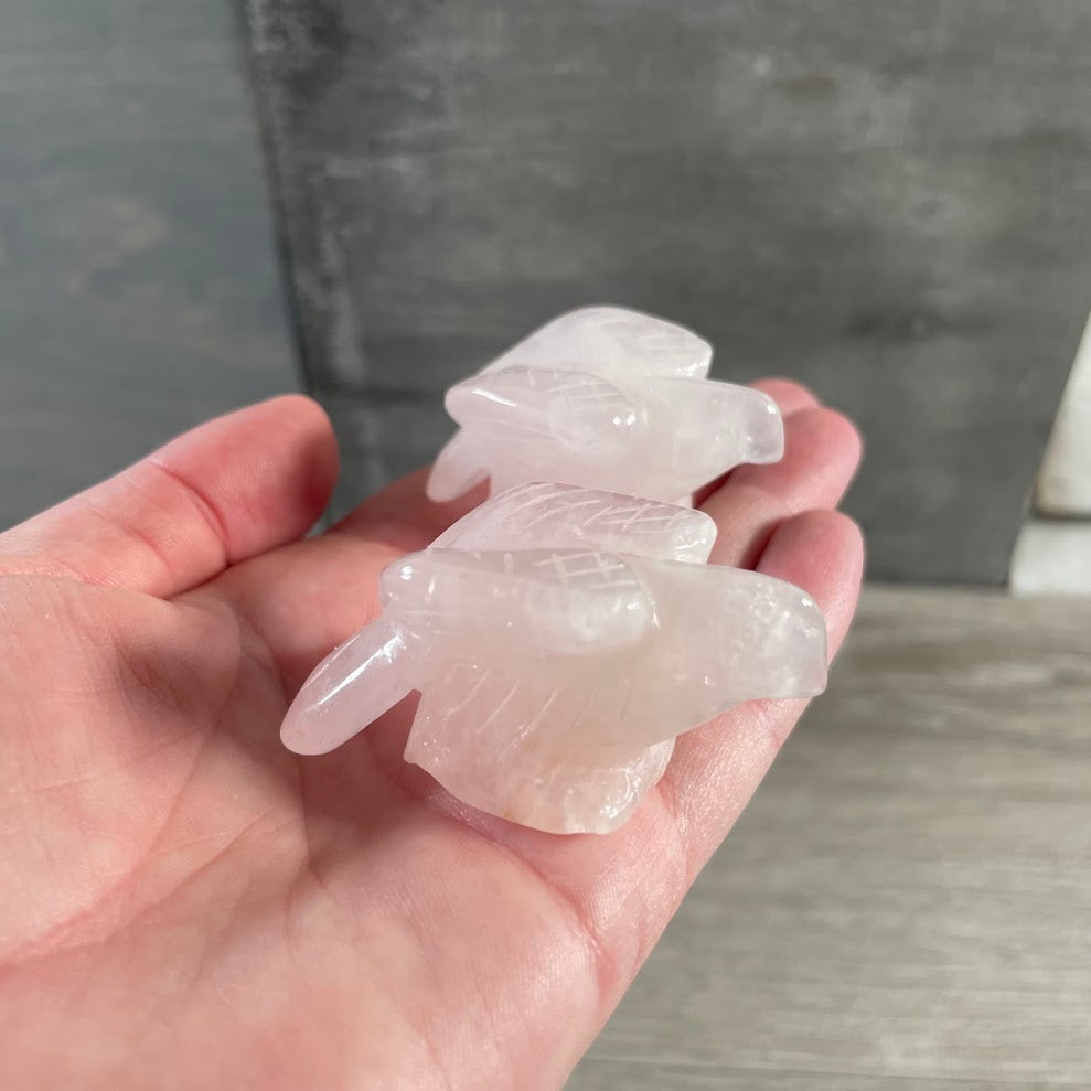 Carved crystal rose quartz eagle figurine made from natural gemstone for rock shop inventory